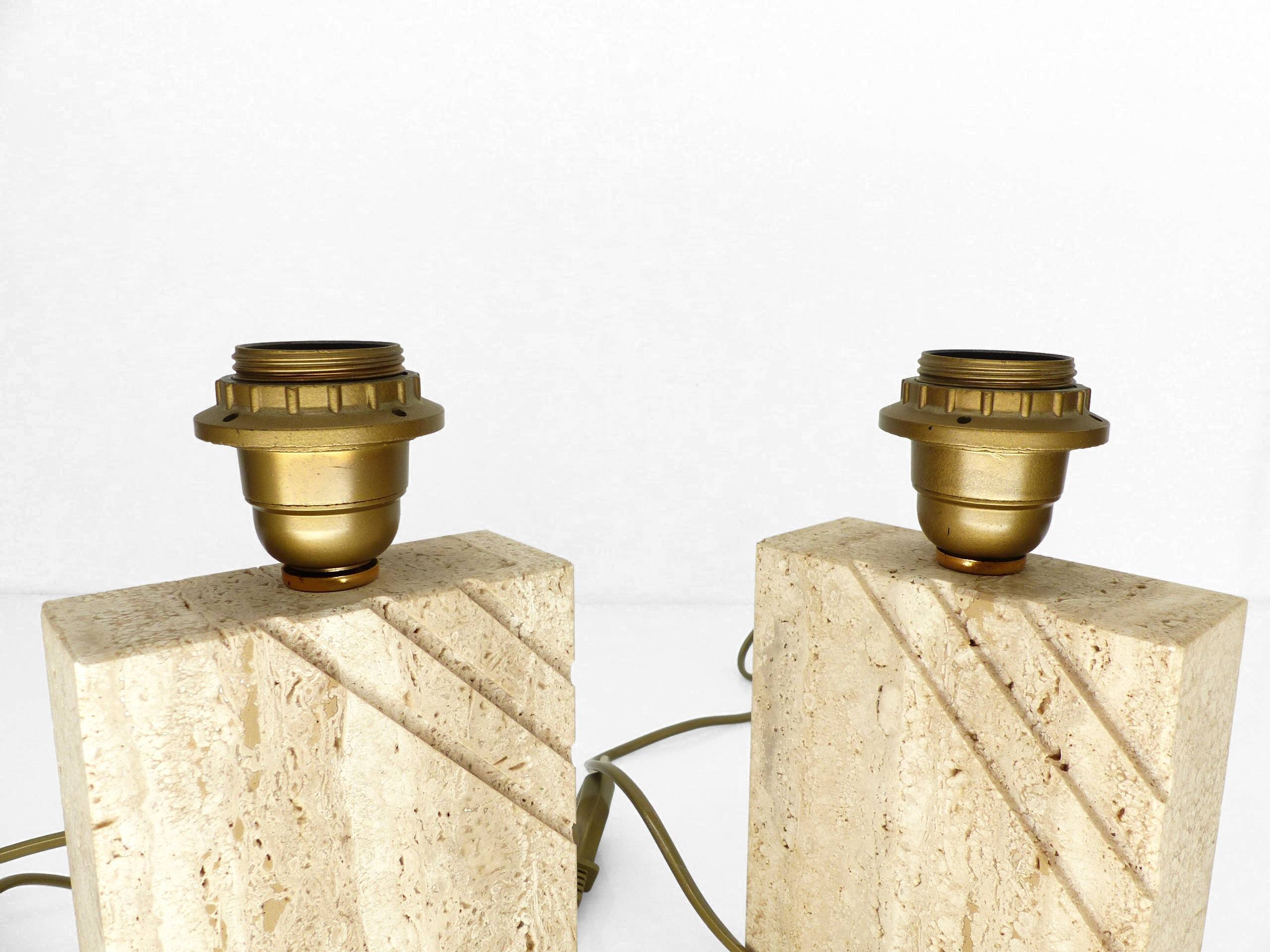 Pair of solid travertine table lamps with incised decoration, French production.