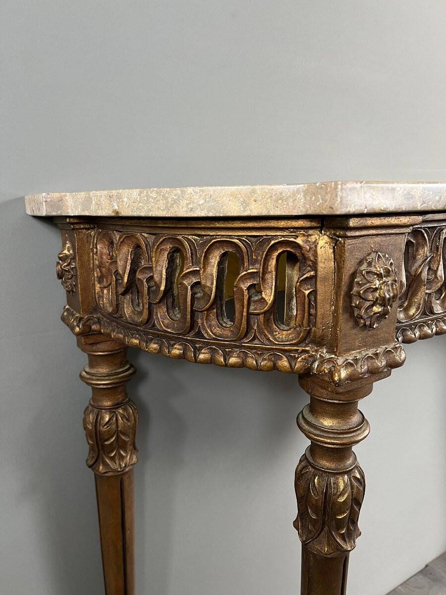 Louis XVI style console in carved wood with a gilded patina, 19th century.