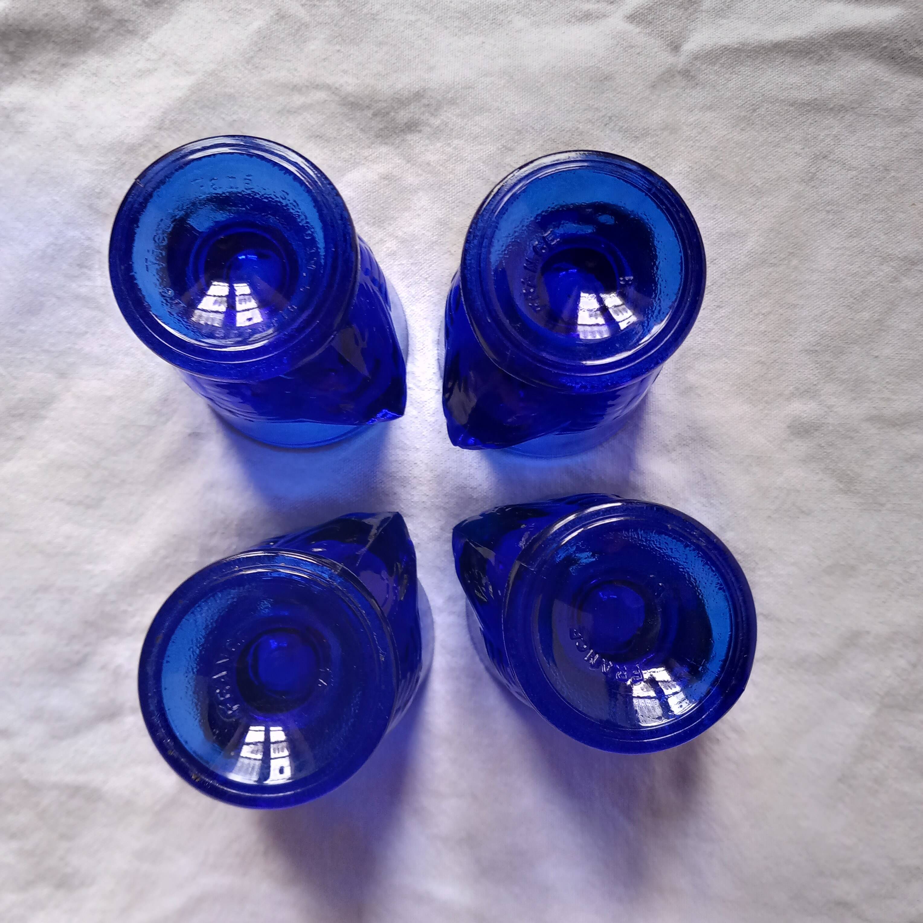 4 chicken-shaped egg cups in cobalt blue glass