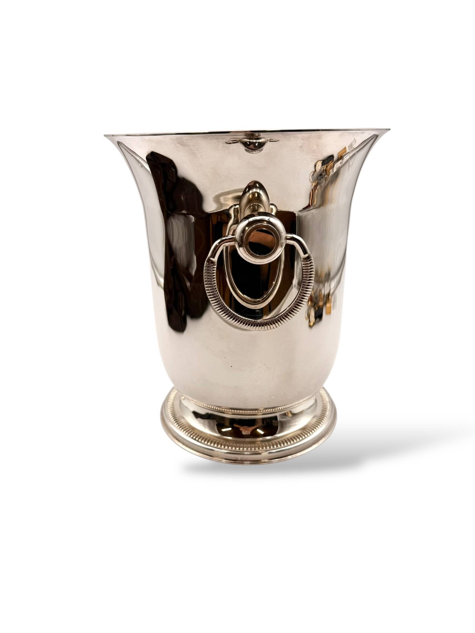 Silver-plated champagne bucket with ring handles.