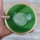 Green glass ashtray set in gold brass