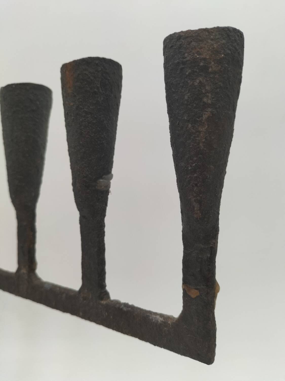 Brutalized wrought iron candle holder