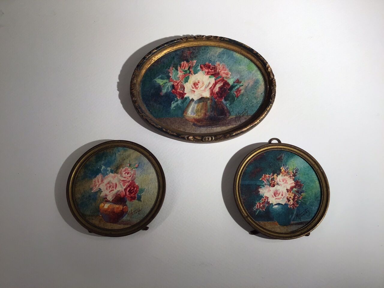 Three old paintings, still lifes with bouquets of roses, signed M Henry