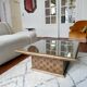 Square table in woven chestnut, with glass top