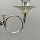 Pair of silver-plated metal candelabra decorated with hunting horns