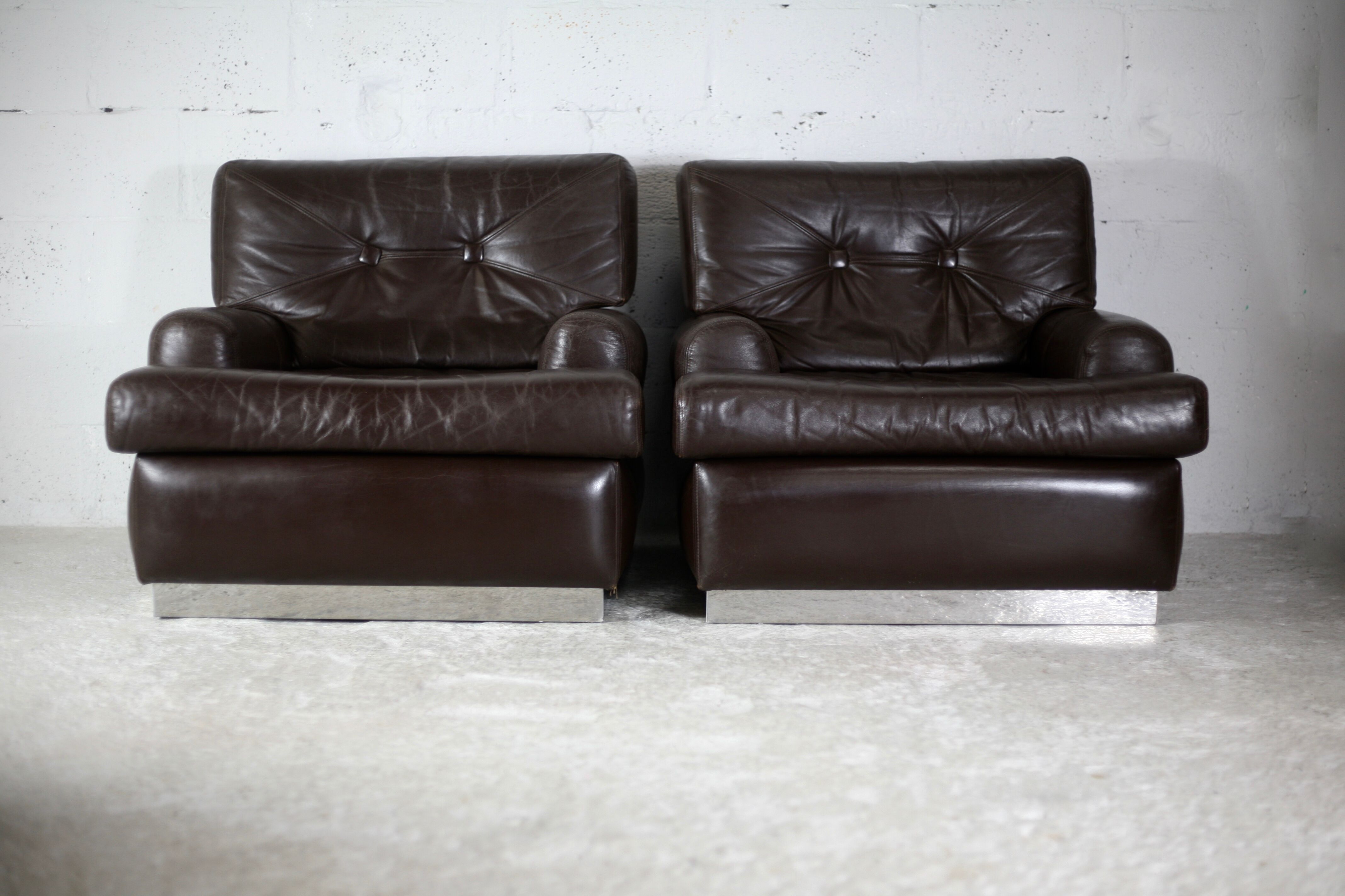 Pair of armchairs brown leather base stainless steel, France, circa 1970