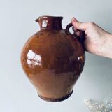 Old pitcher in glazed terracotta
