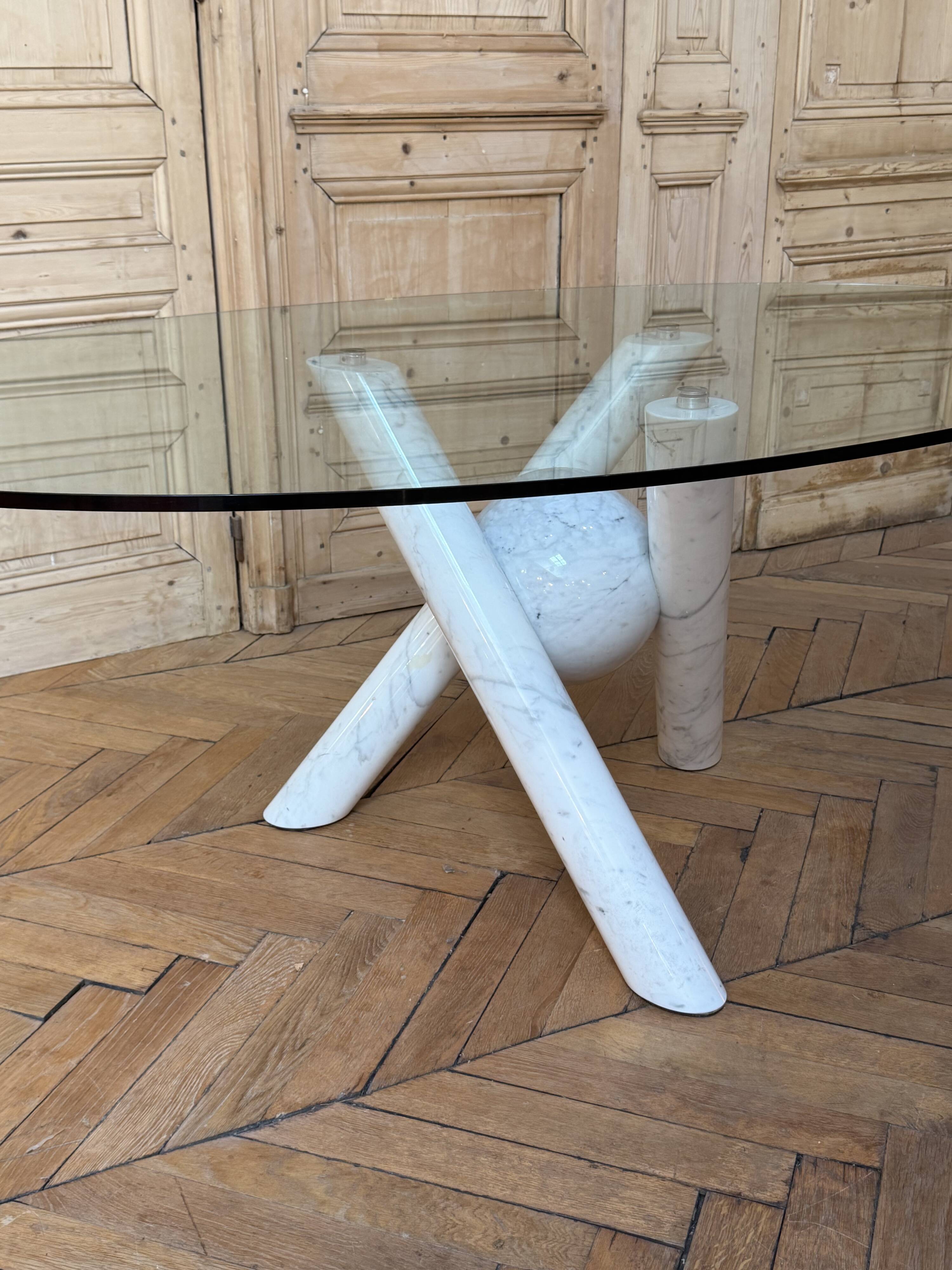 Dining table with glass top and marble base, Ligne Roset.