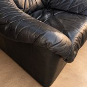 Leather armchairs and matching pouf, Italy, circa 1980