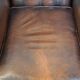 Chesterfield wing chair in dark brown leather with a luxurious appearance