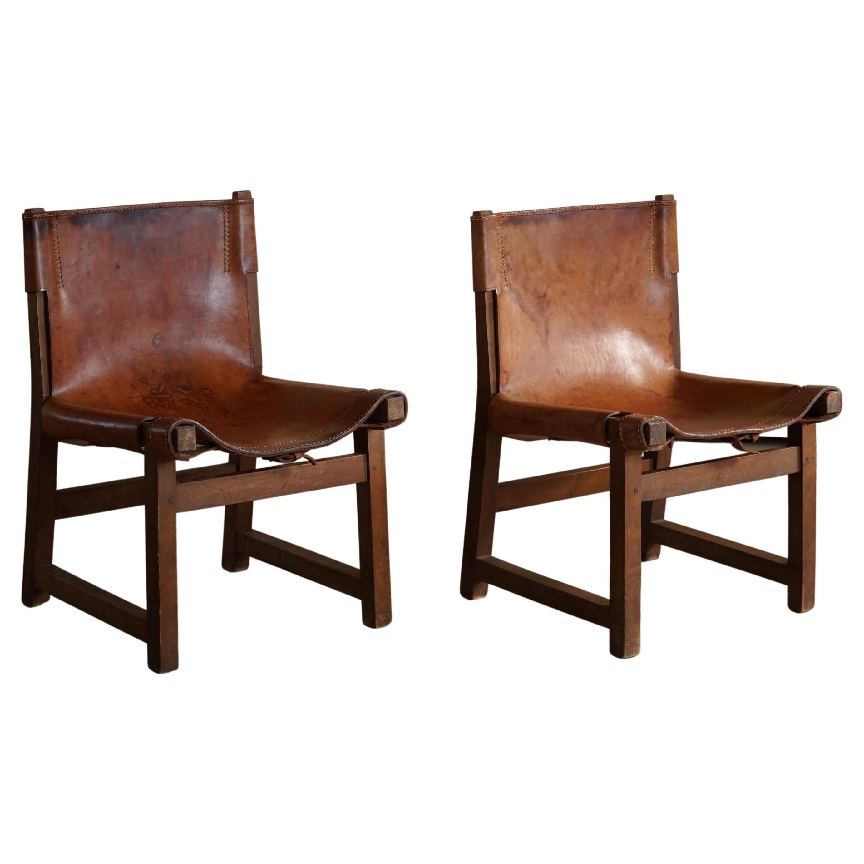 Paco Muñoz, Pair of lounge hunting armchairs, model "Riaza", leather and walnut, 1960