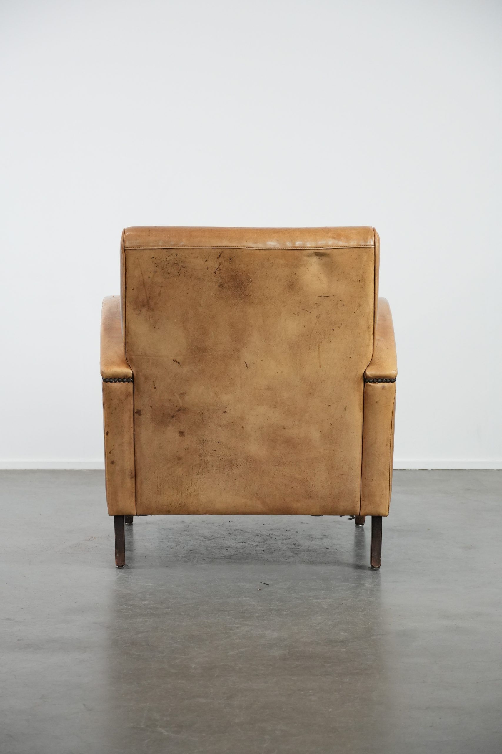 Luxury armchair made of cowhide leather with a beautiful warm colour scheme