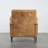 Luxury armchair made of cowhide leather with a beautiful warm colour scheme