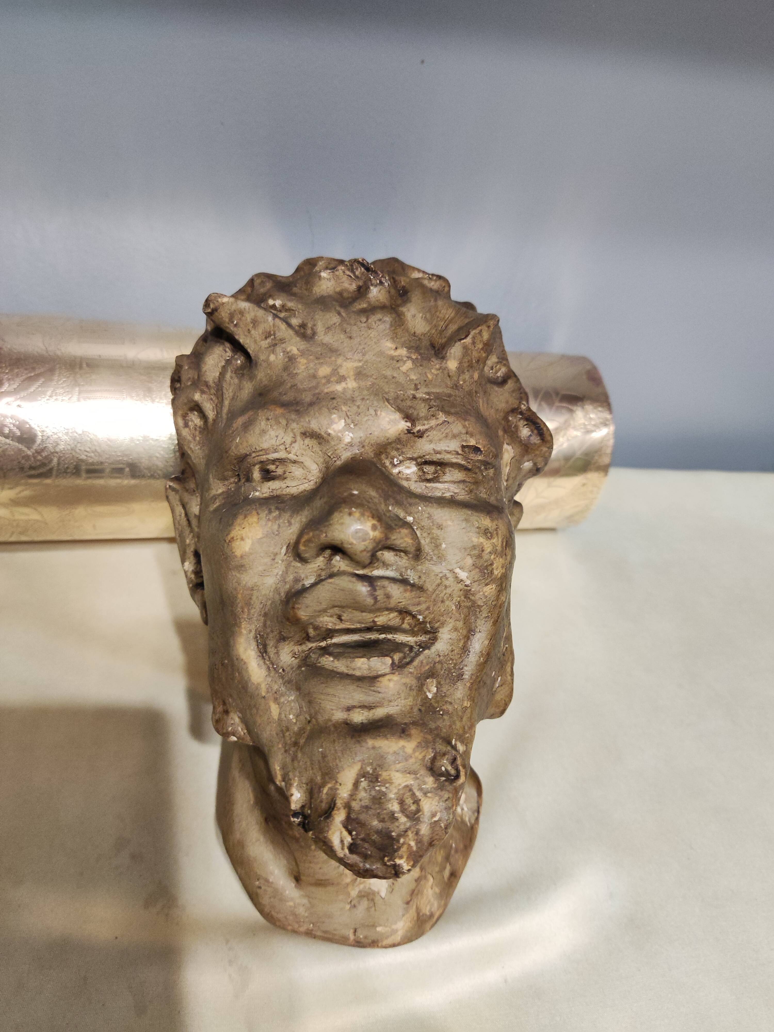 Head of satire in plaster