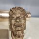 Head of satire in plaster