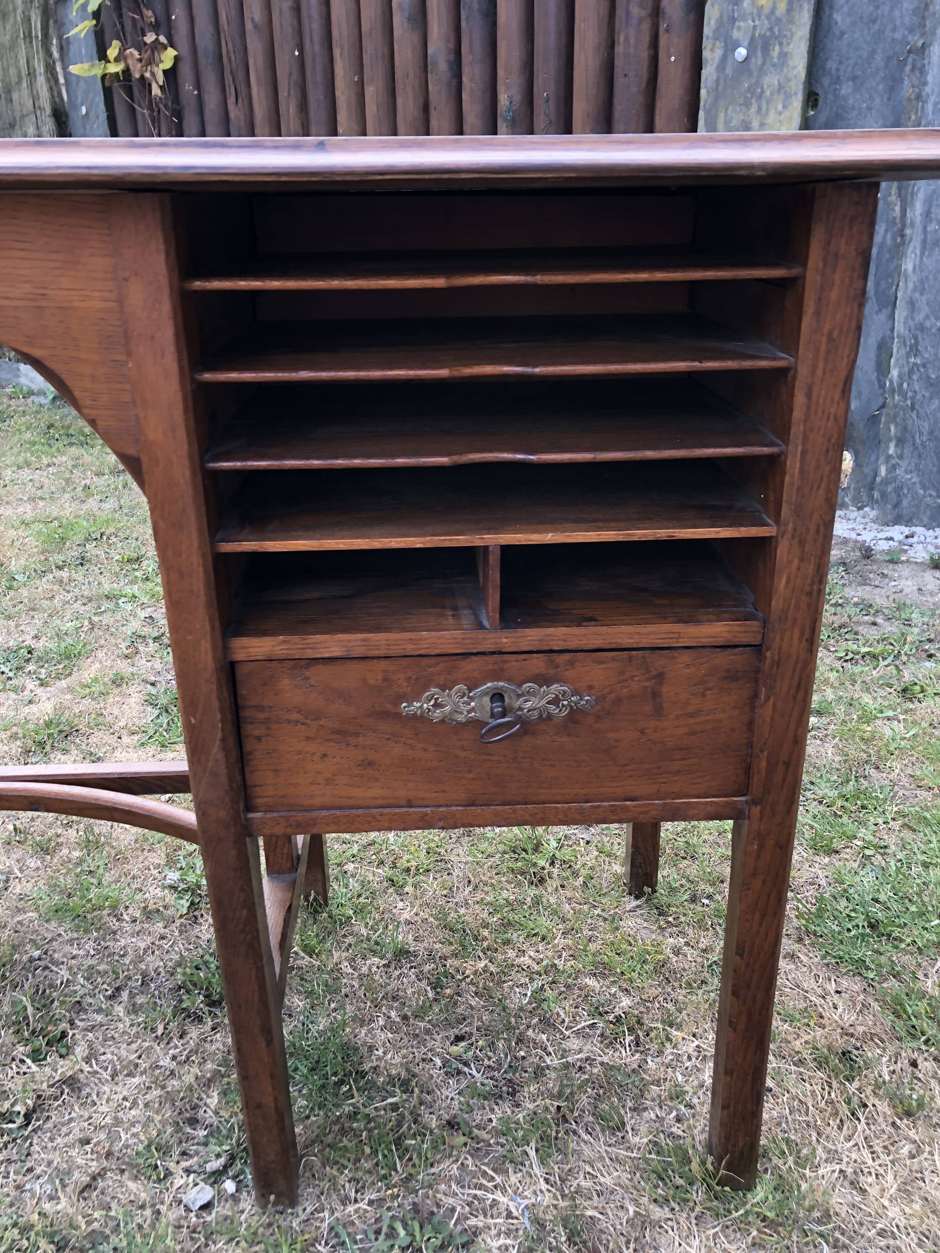 Old oak desk with curved wooden sleepers in the Art Nouveau spirit of the early 20th century.