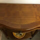 Cherry half-moon console with drawer and bottom shelf