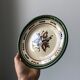 Very decorative serving plate in terracotta, floral and geometric motifs.