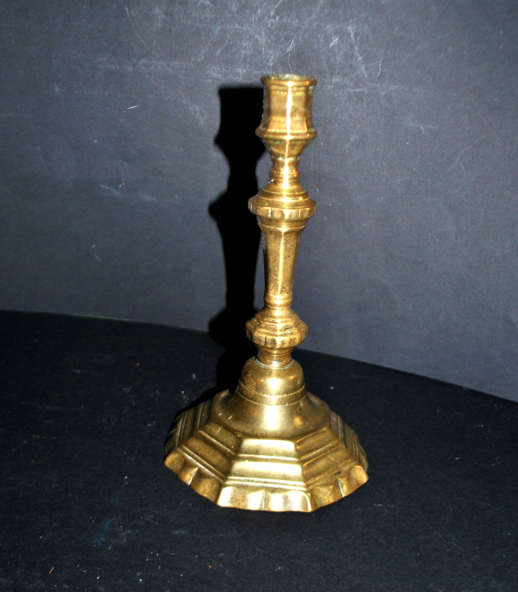 Antique 18th-century octagonal cut-out bronze candlestick in the Louis XIV style.