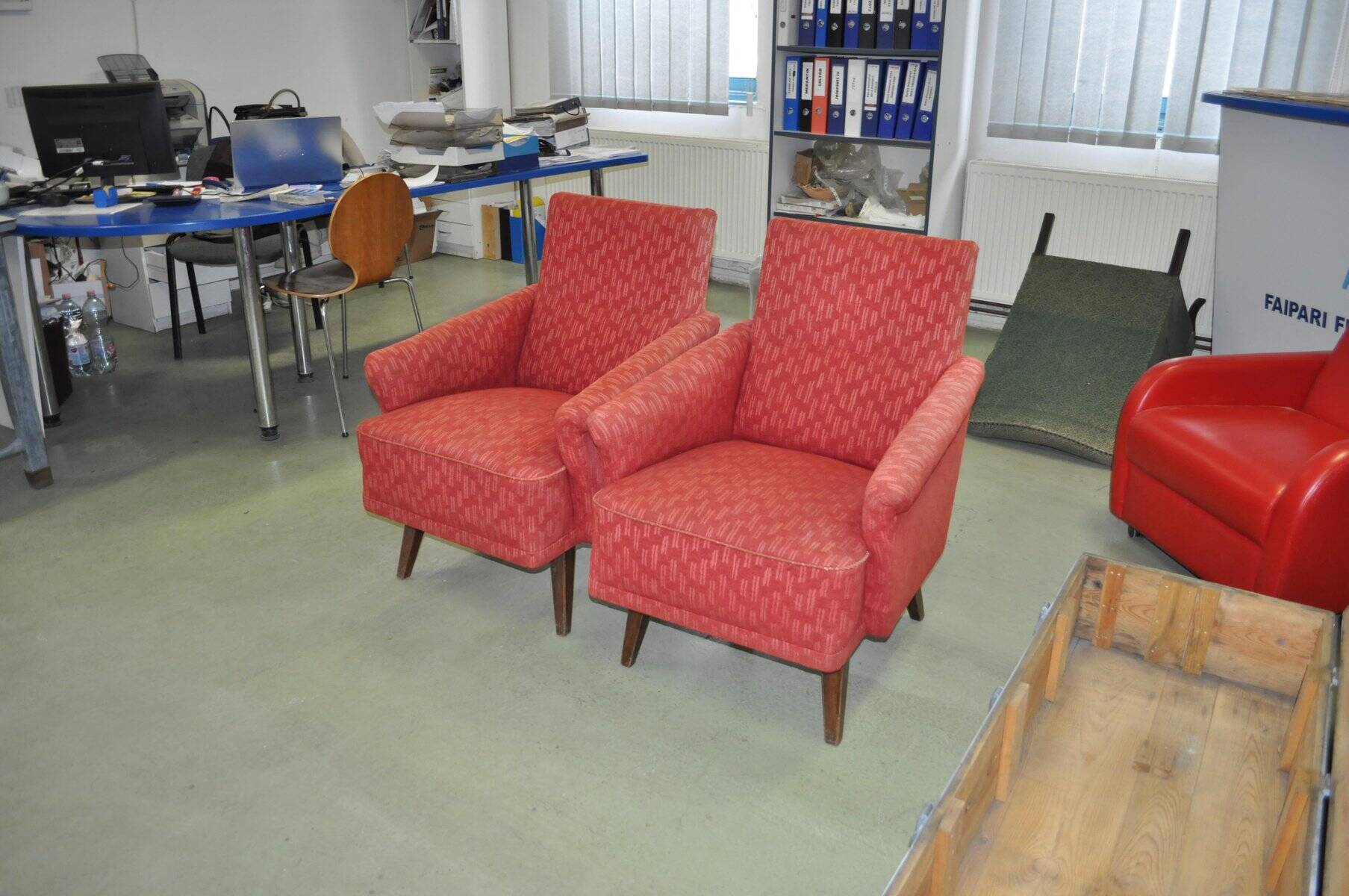 Pair of Mid-Century armchairs in red and brown fabric with dark wooden legs.