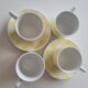 4 cups, 2 under cups yellow and white tea towel pattern