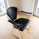 Pair of Linda Arrben armchairs from the 1970s in metal and black leather.