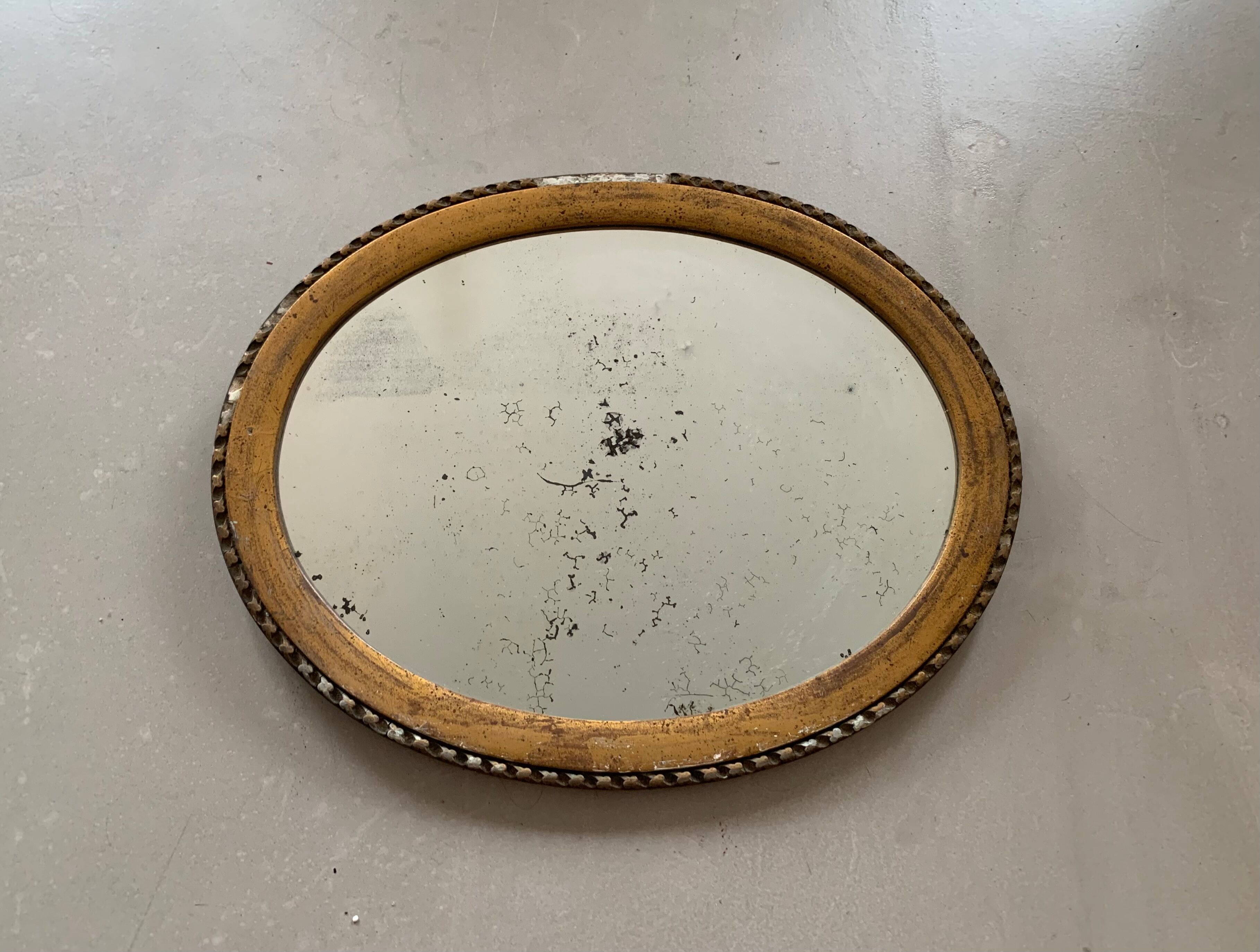 Old oval mirror stitched