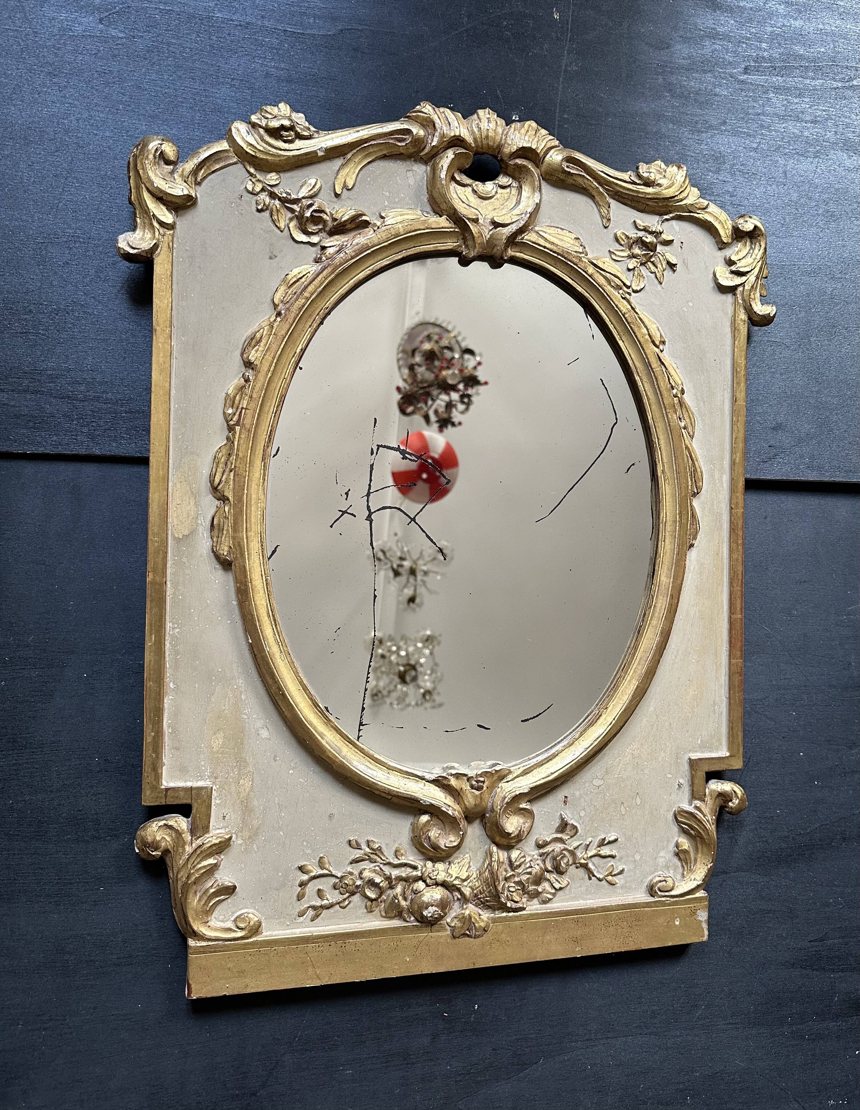 Napoleon III mirror in carved gilded wood, oval mercury glass.