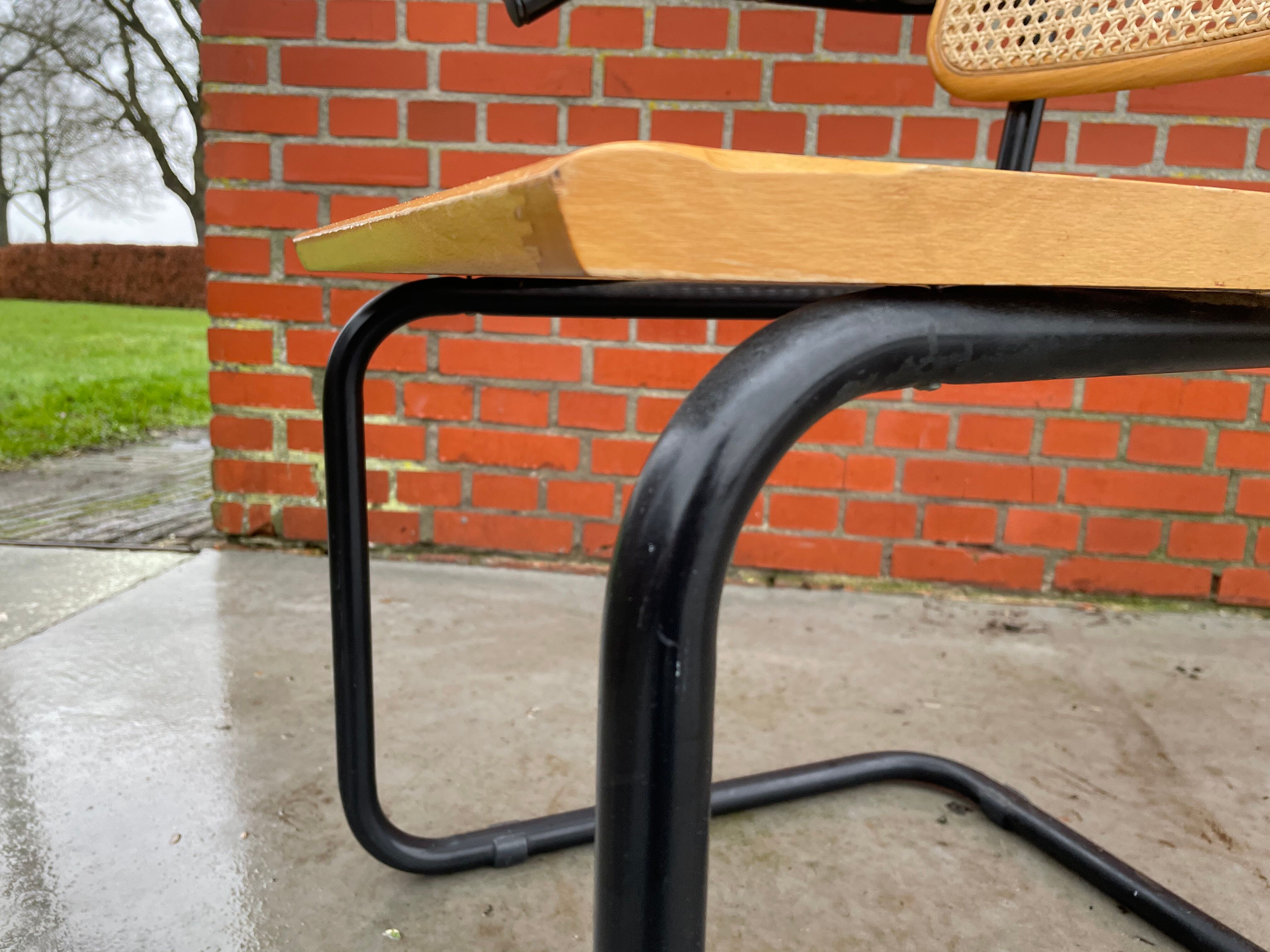 Cesca model chair designed by Marcel Breuer with black-framed armrests