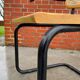 Cesca model chair designed by Marcel Breuer with black-framed armrests