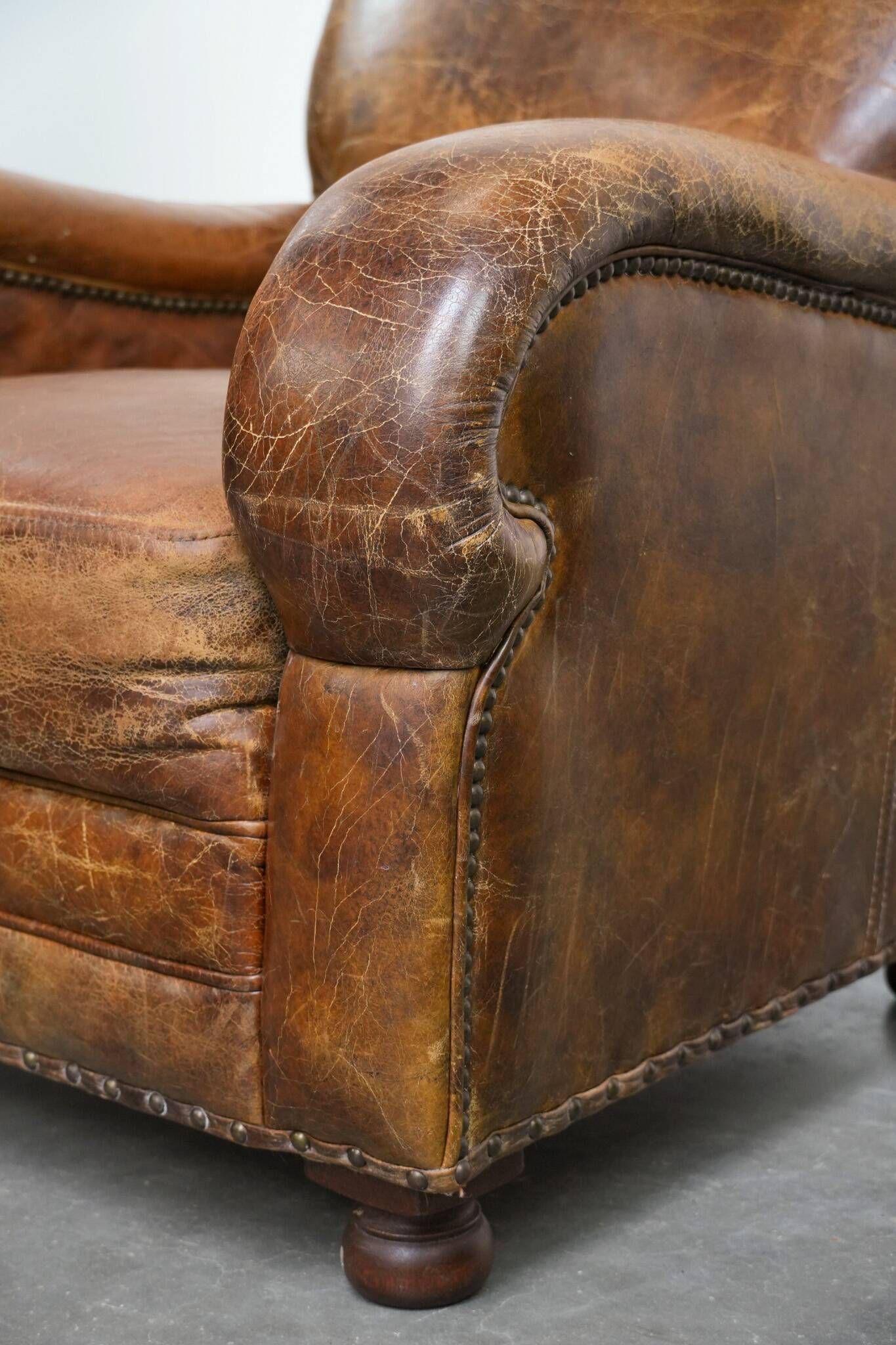 Charming and comfortable vintage armchair in grained cowhide leather with character