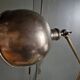 Old adjustable industrial lamp in bronze with 2 arms.