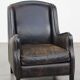 Black cow leather armchair in industrial style finished with decorative nails