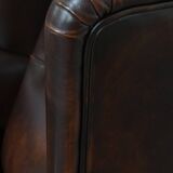 Comfortable wingback chair in English style made of cowhide leather