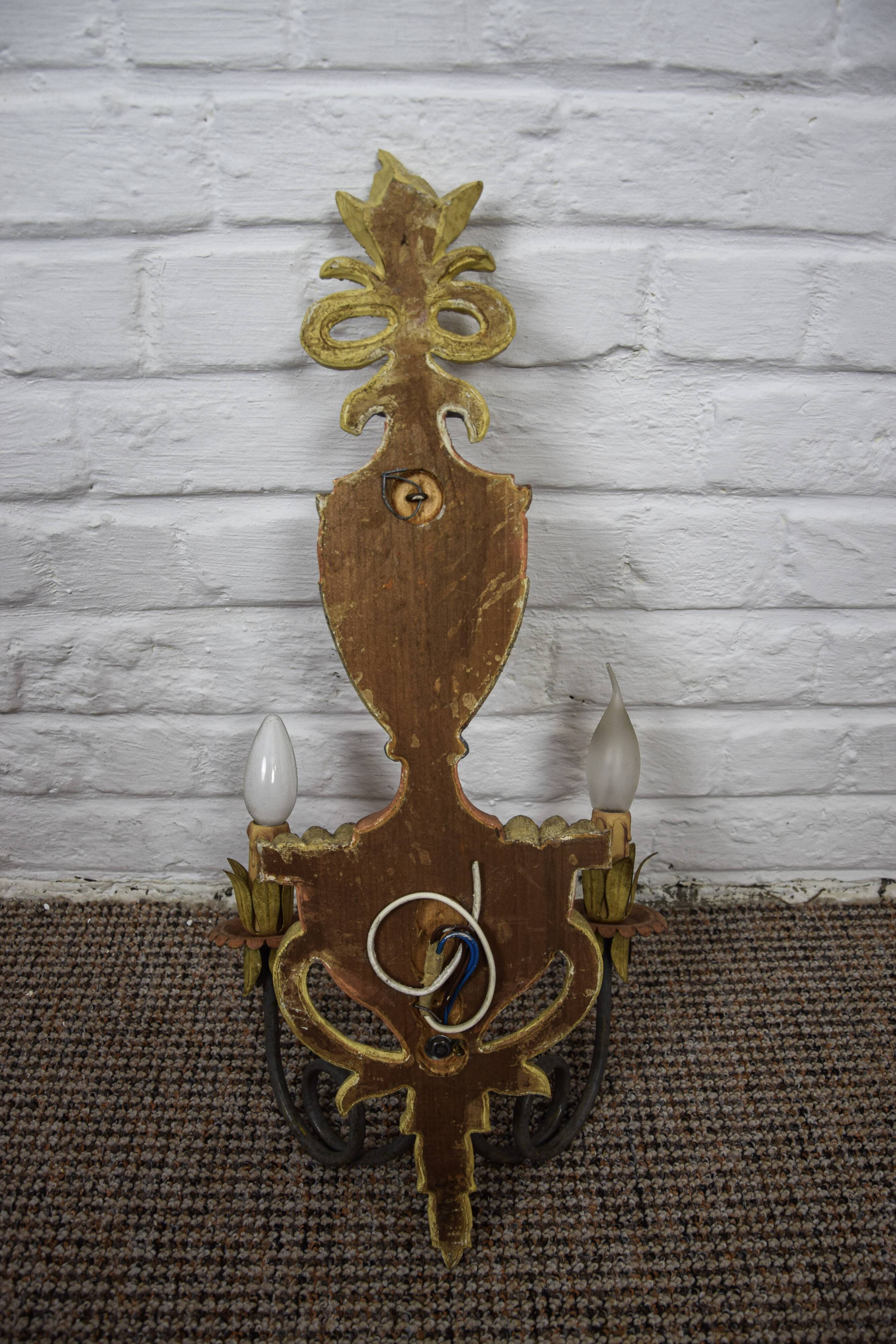 Pair of patinated wood sconces