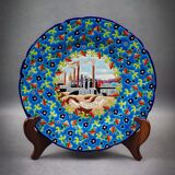 Longwy plate with polychrome enamels, decorated with the "City of Iron" motif.