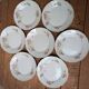 7 dessert plates in porcelain with a violet lilac design and a gold rim.