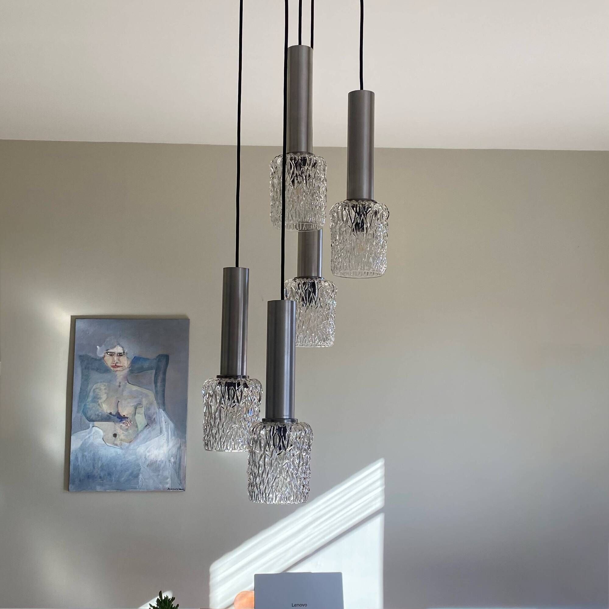 Large cascading chandelier with 5 glass lampshades and aluminium tube.
