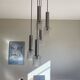 Large cascading chandelier with 5 glass lampshades and aluminium tube.