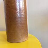 Old stoneware bottle with small handle and labels