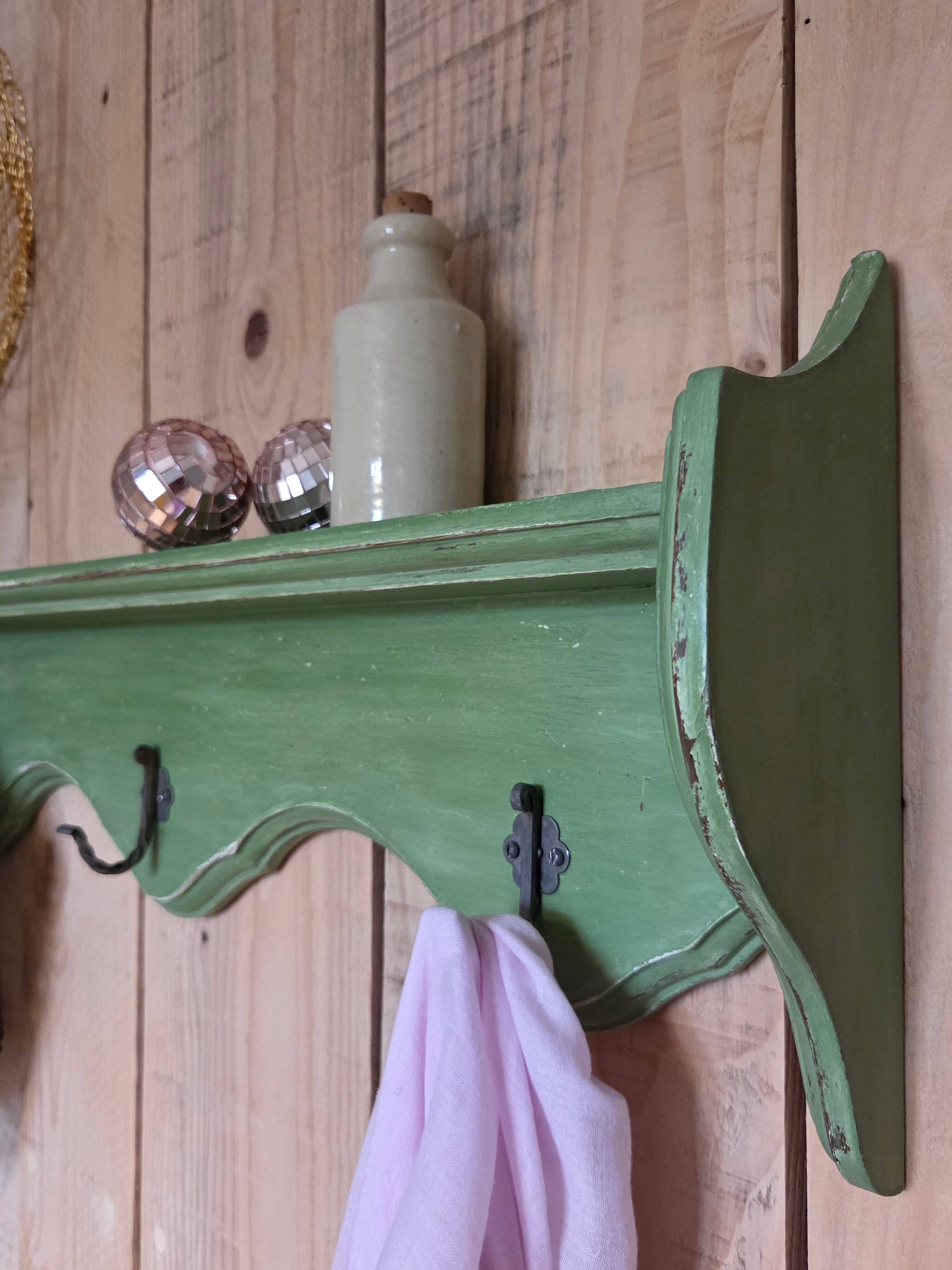Antique wall shelf with a green patina