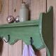 Antique wall shelf with a green patina