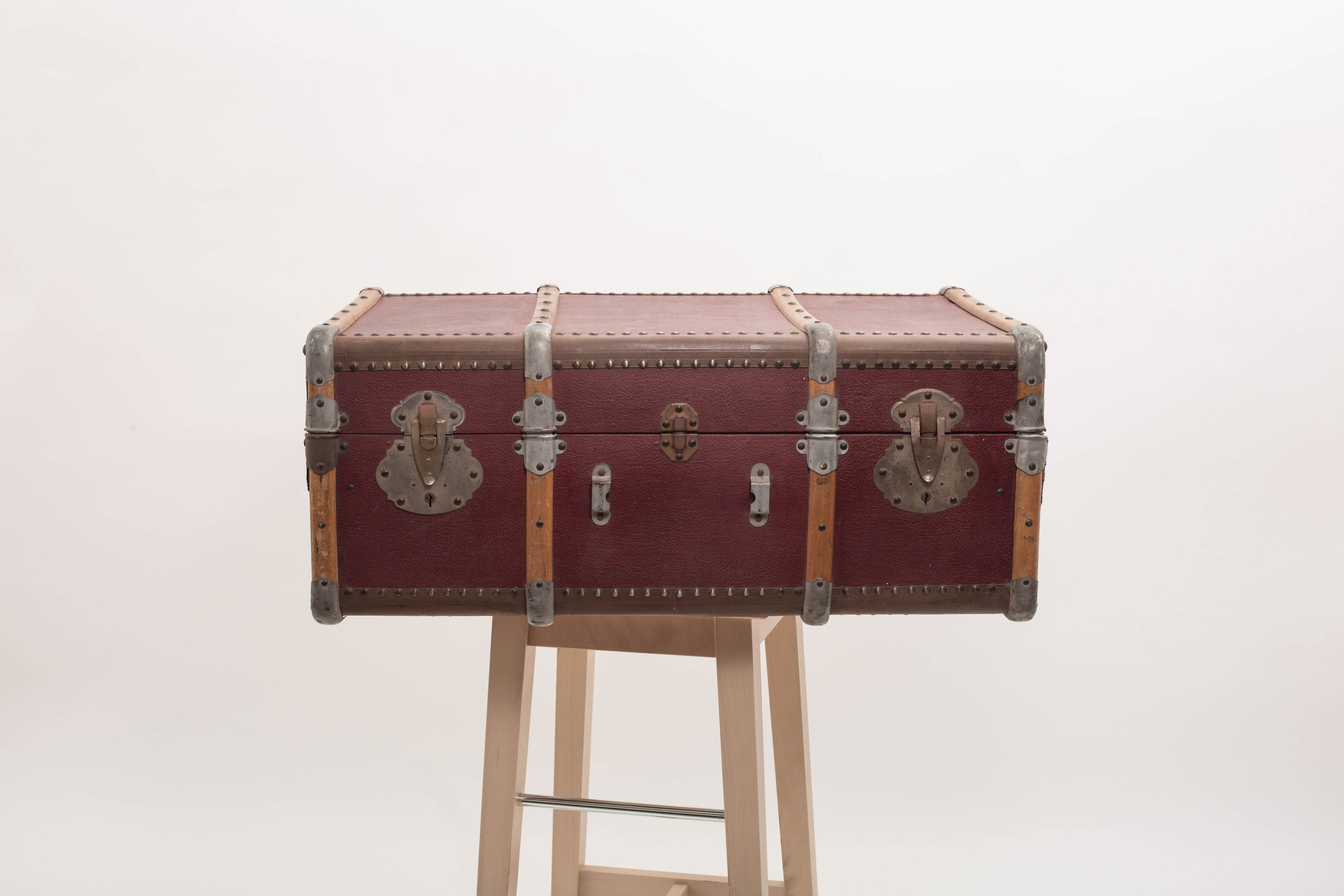 Old trunk travel suitcase burgundy color