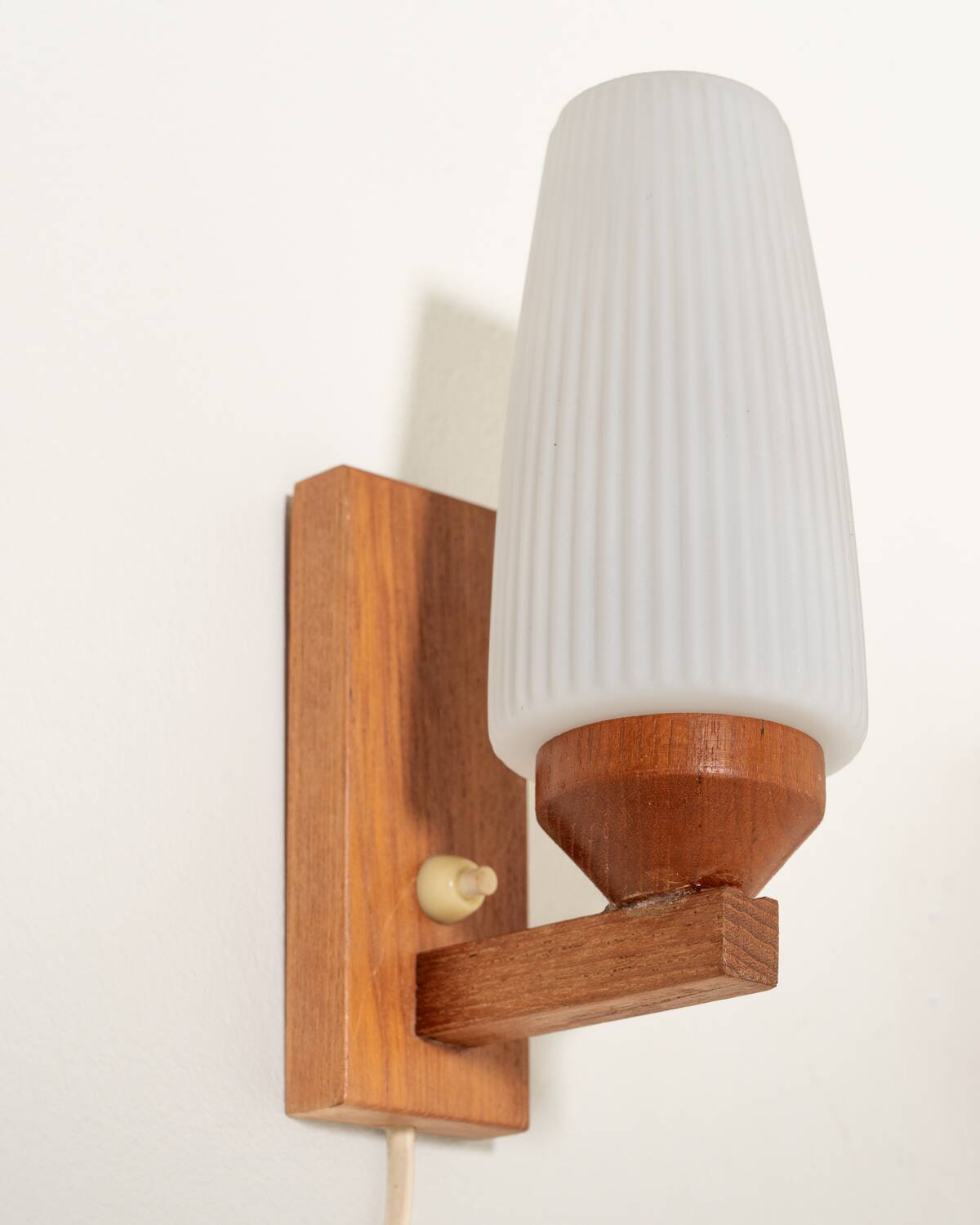 Pair of teak and opaline glass wall lamps, 1950s/1960s