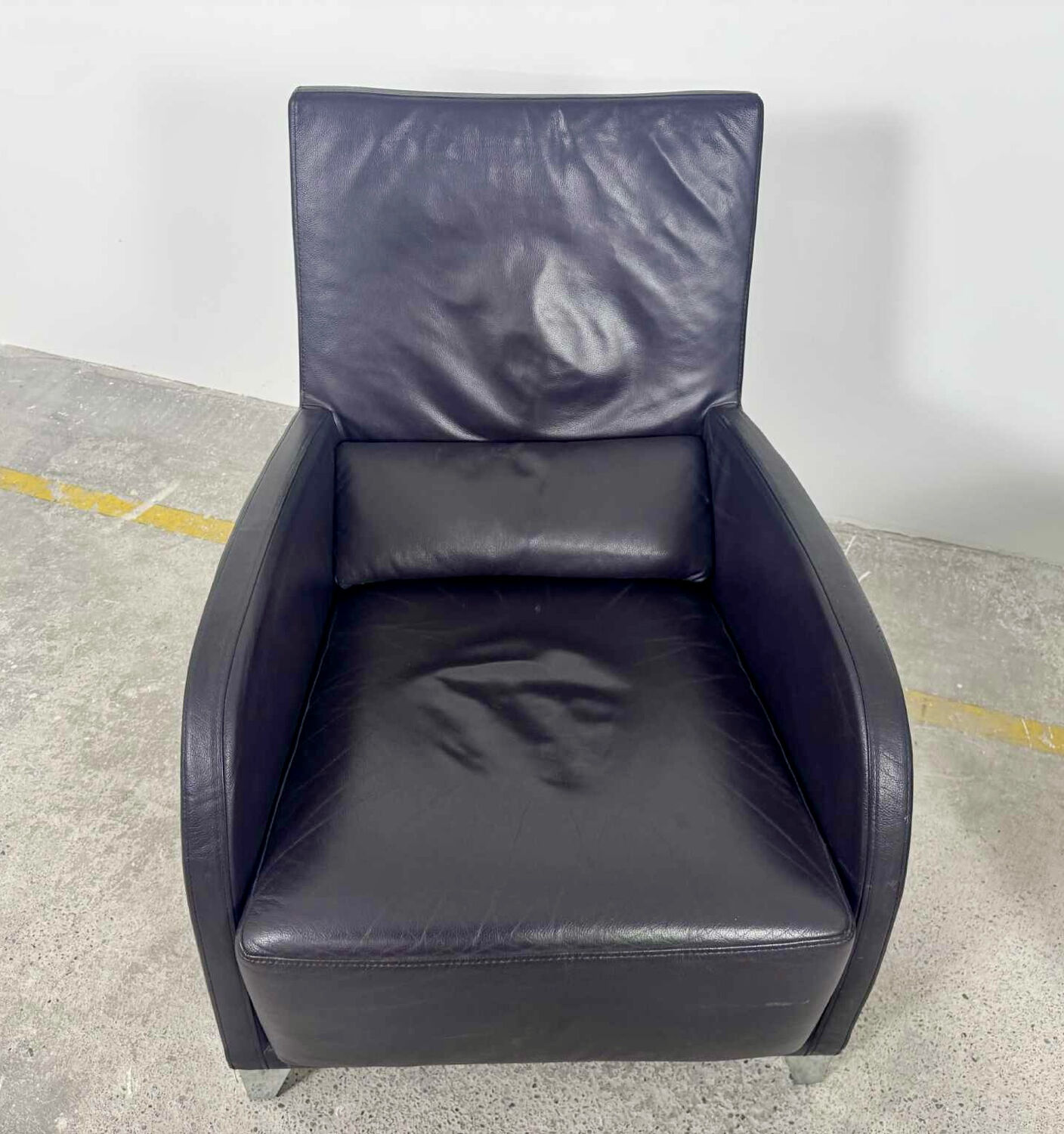 Pair of aubergine leather club armchairs by Cinna.