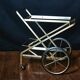 Vintage rolling trolley in gold metal & smoked glass – Retro elegance as
