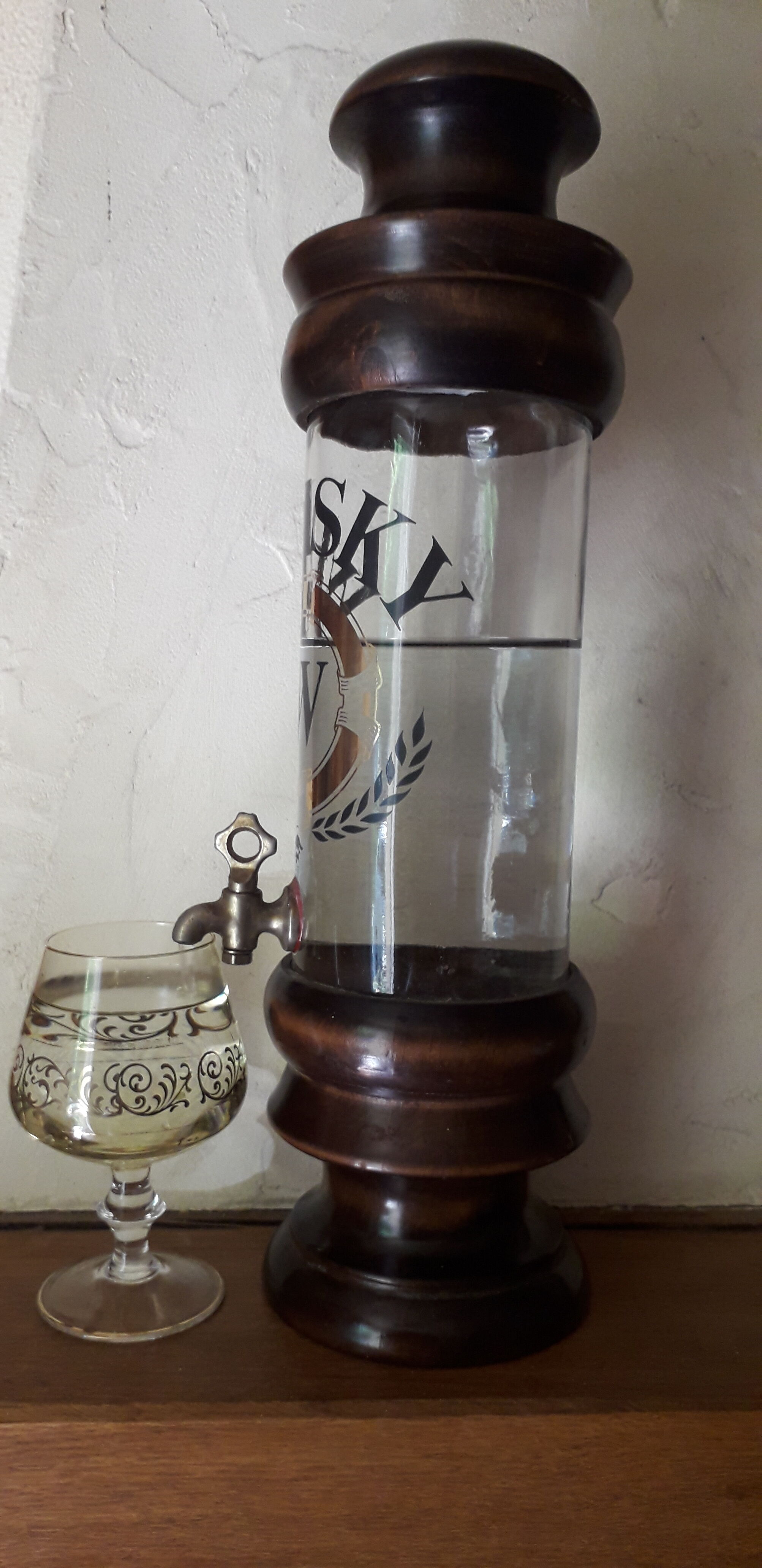 Vintage glass and wood whiskey bottle with pouring tap