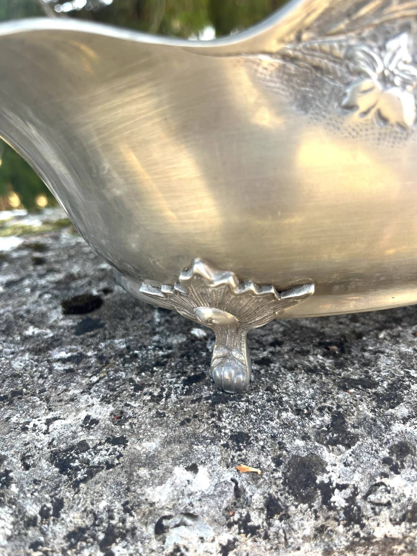 Footed pewter champagne cooler on claw feet with floral relief