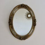 Oval wall mirror, golden floral pattern in stucco and wood, late 19th century