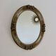 Oval wall mirror, golden floral pattern in stucco and wood, late 19th century